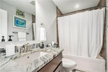 Main Level Guest Bathroom featuring Tile and Granite